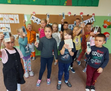 Zdjęcie przedstawia przedszkolaki podczas akcji 'Narodowe Czytanie'. - powiększ